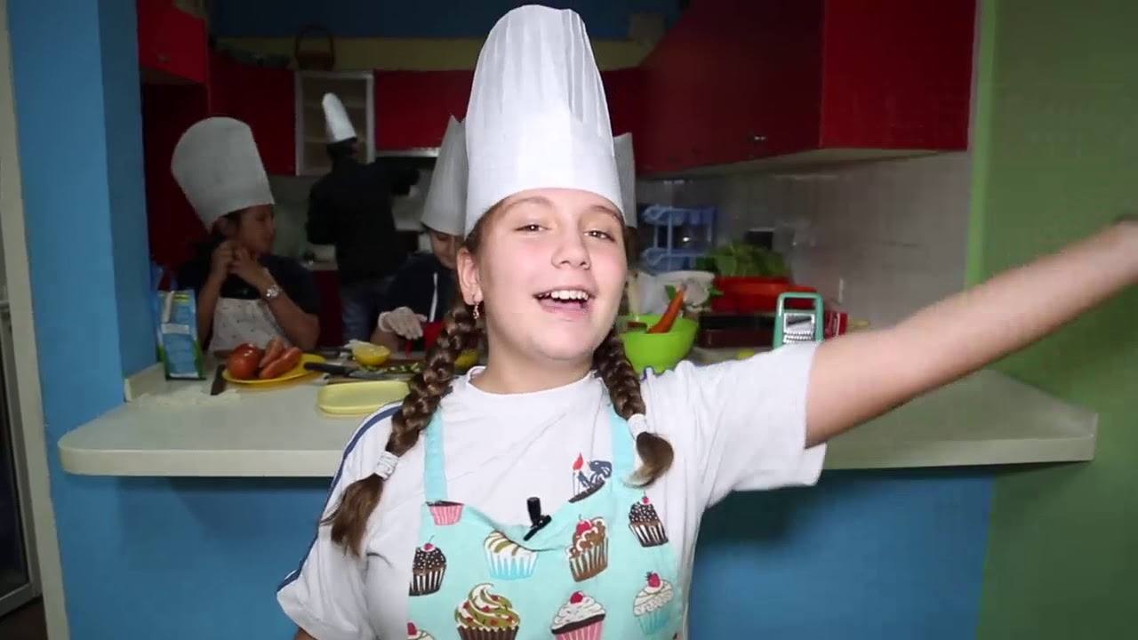 A pupil in chef whites during a life-skills cooking lesson